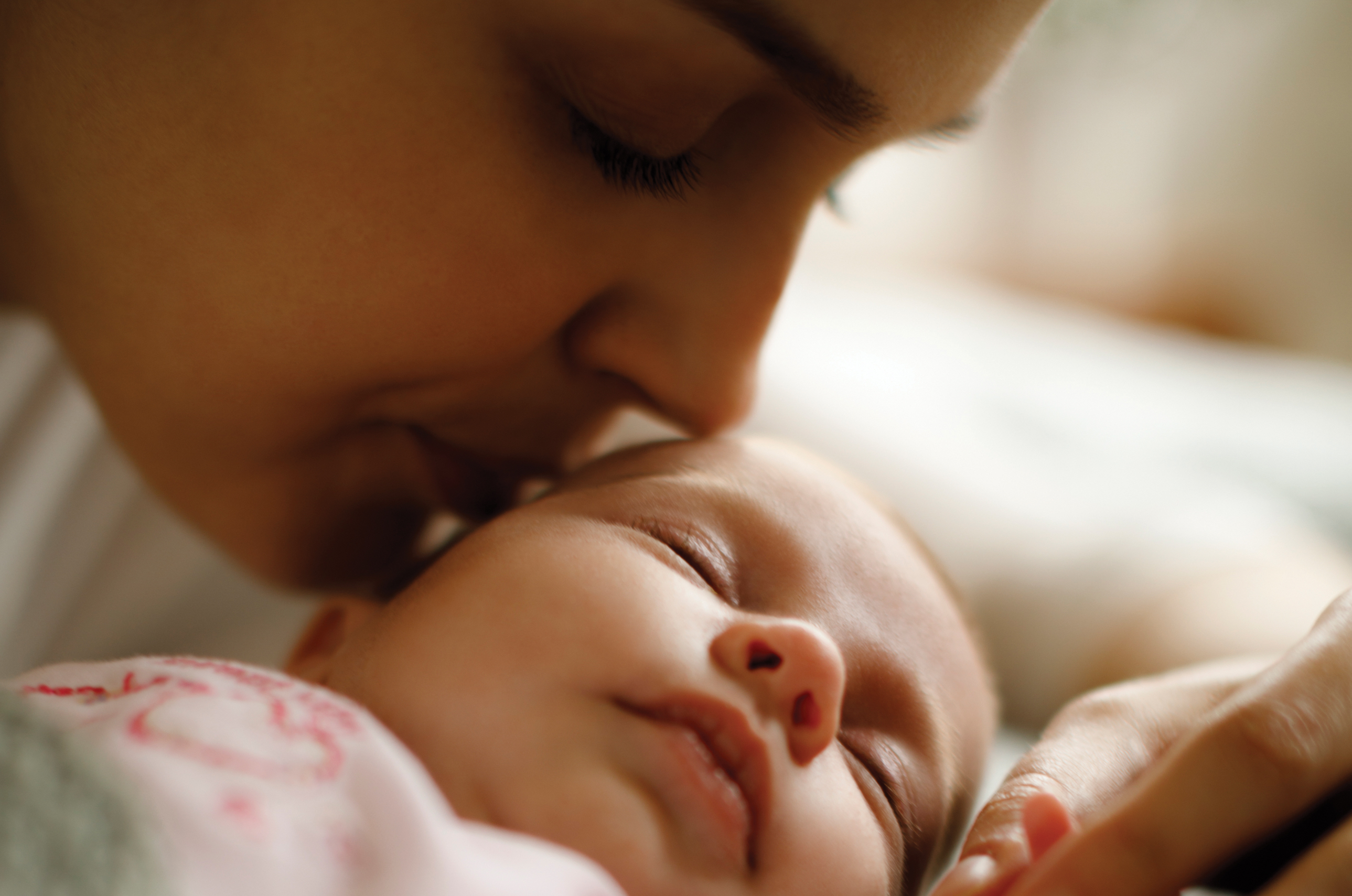 Mother kissing her baby.