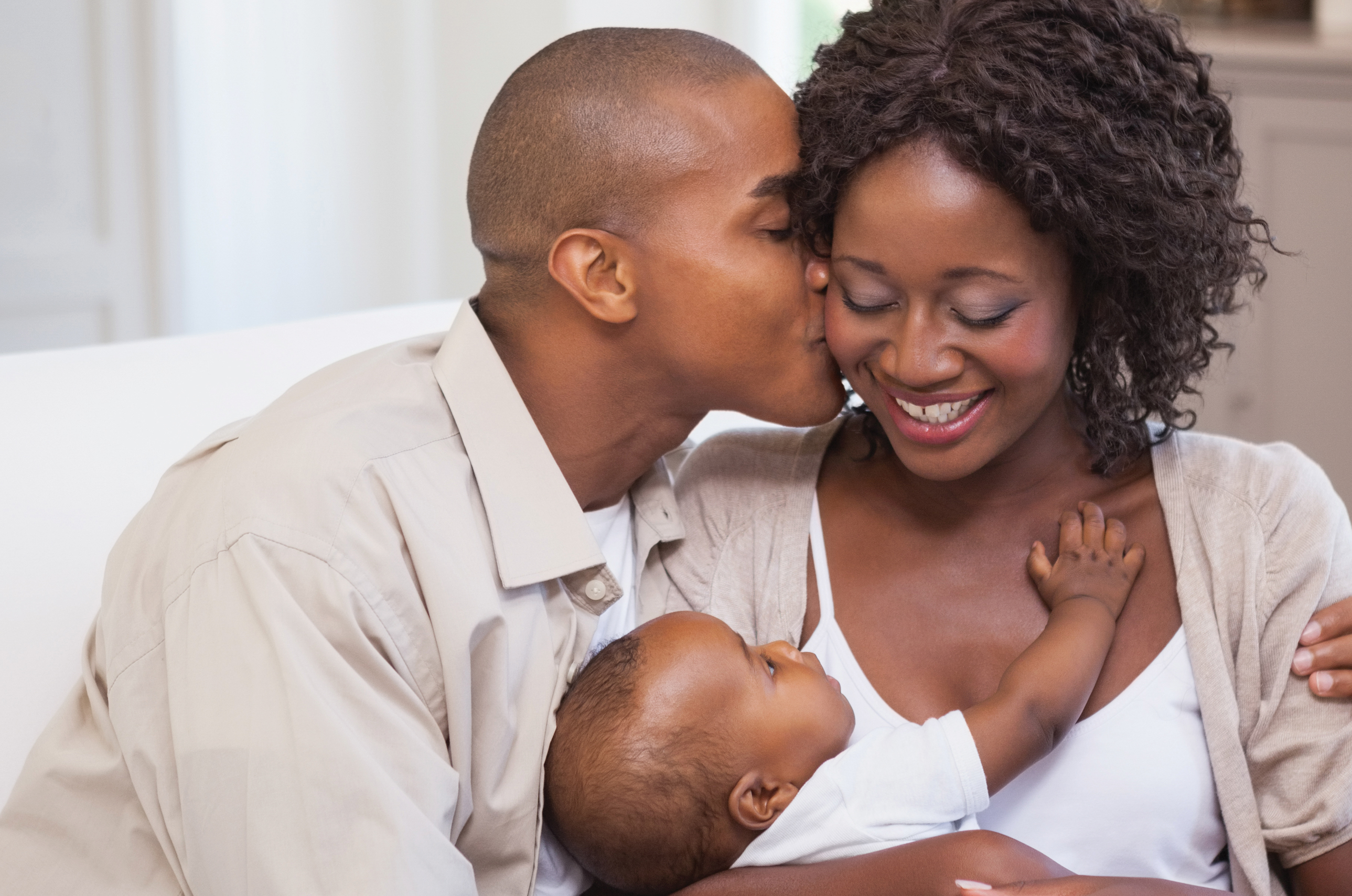 Mother and father holding a baby