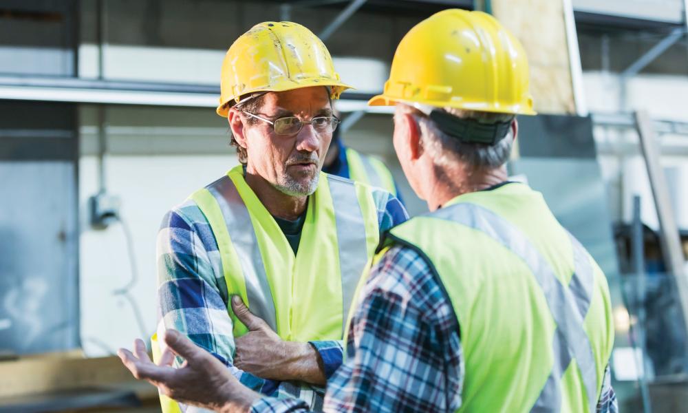 Two men at work talking.