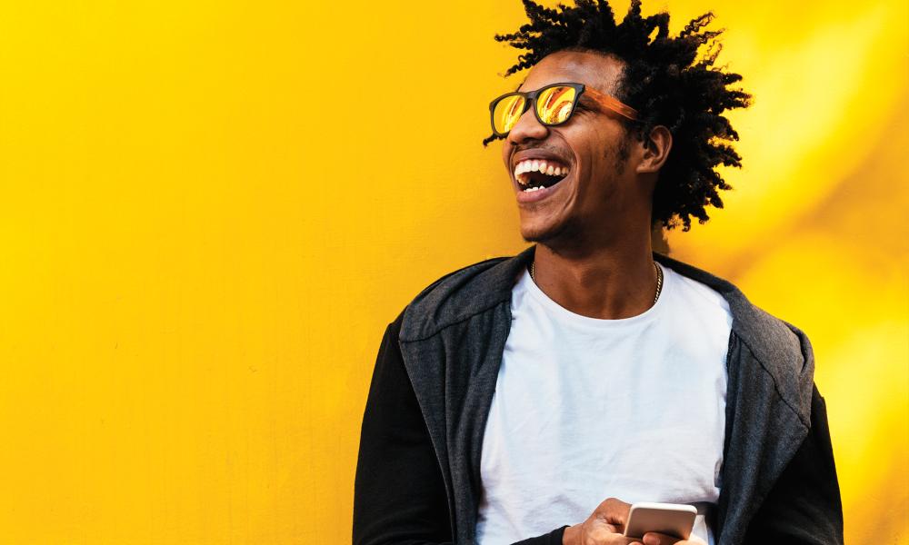 Man holding phone smiling