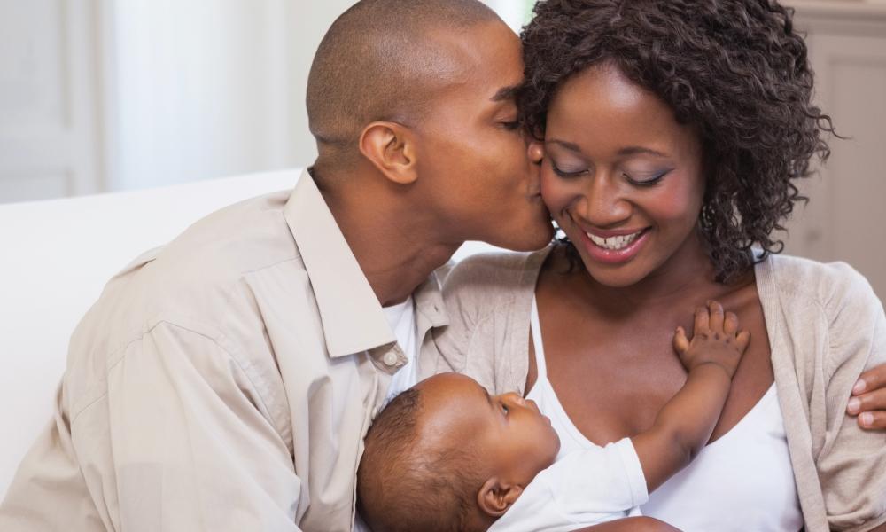 Mother and father holding a baby