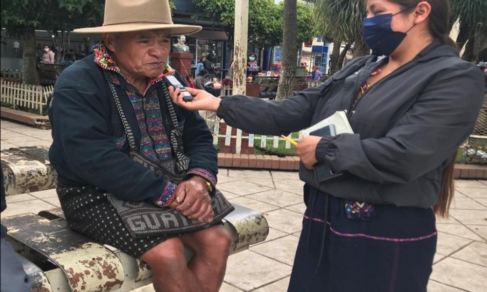 Staff member interviews local man about culture.
