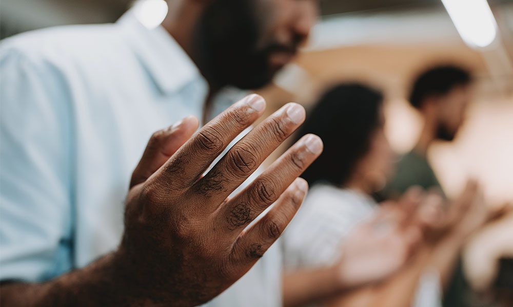 Man with hands lifted in prayer