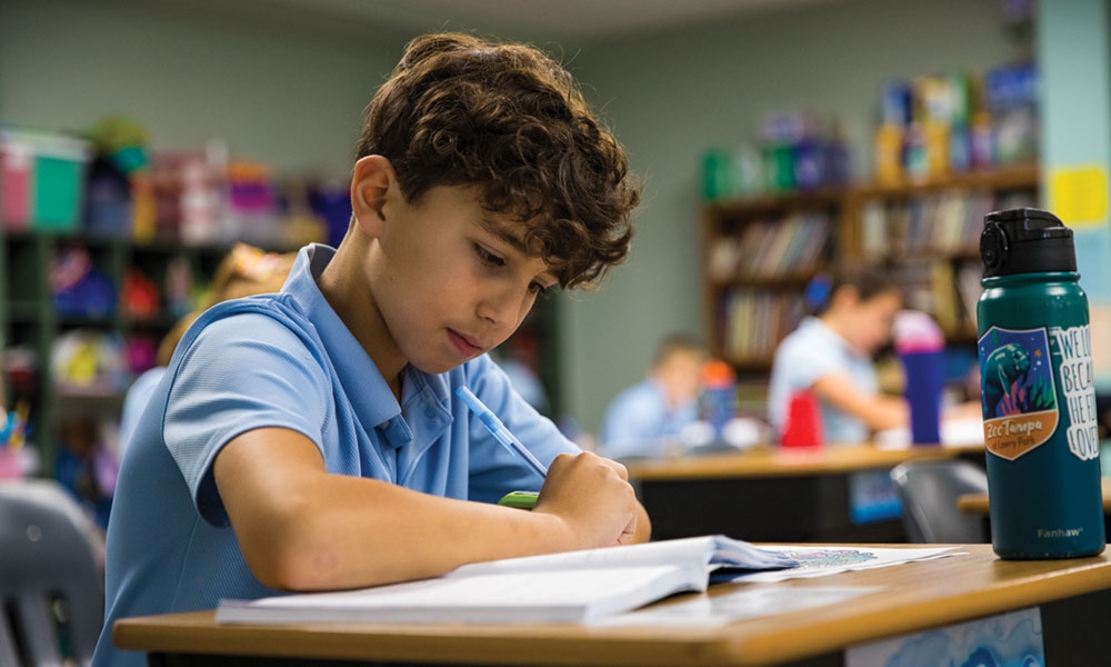 Student studying a book in class