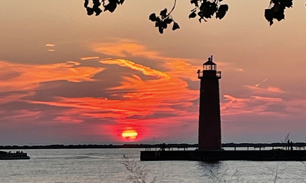 Sunset behind a lighthouse