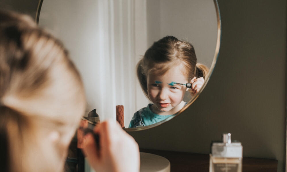 Little girl incorrectly applies makeup to her face