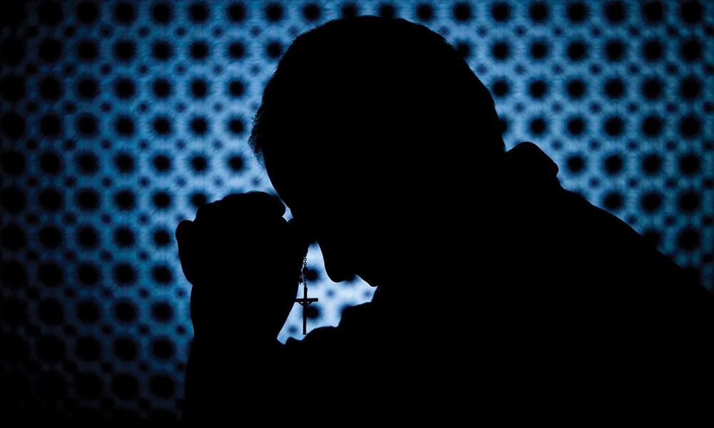 Silhouette of a man praying