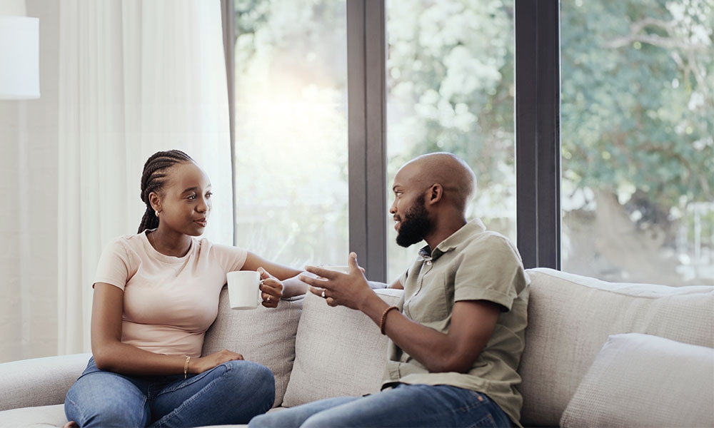 Unapologetic about the faith. A man and woman speaking in a living room.