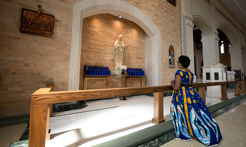 Alphonsine Busabusa praying at an altar